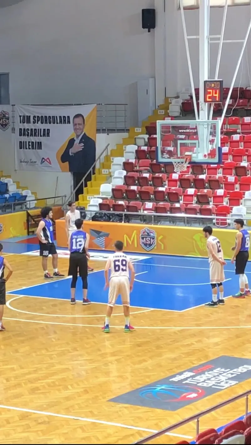 A youth league game, players lined up along the key for a free throw
